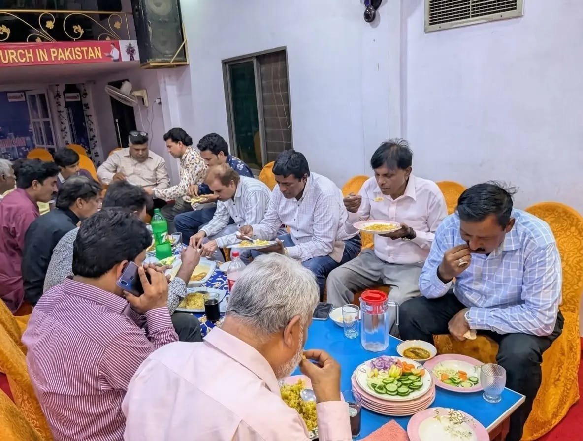 Church community sharing fellowship and support at Church of Christ Assembly in Pakistan