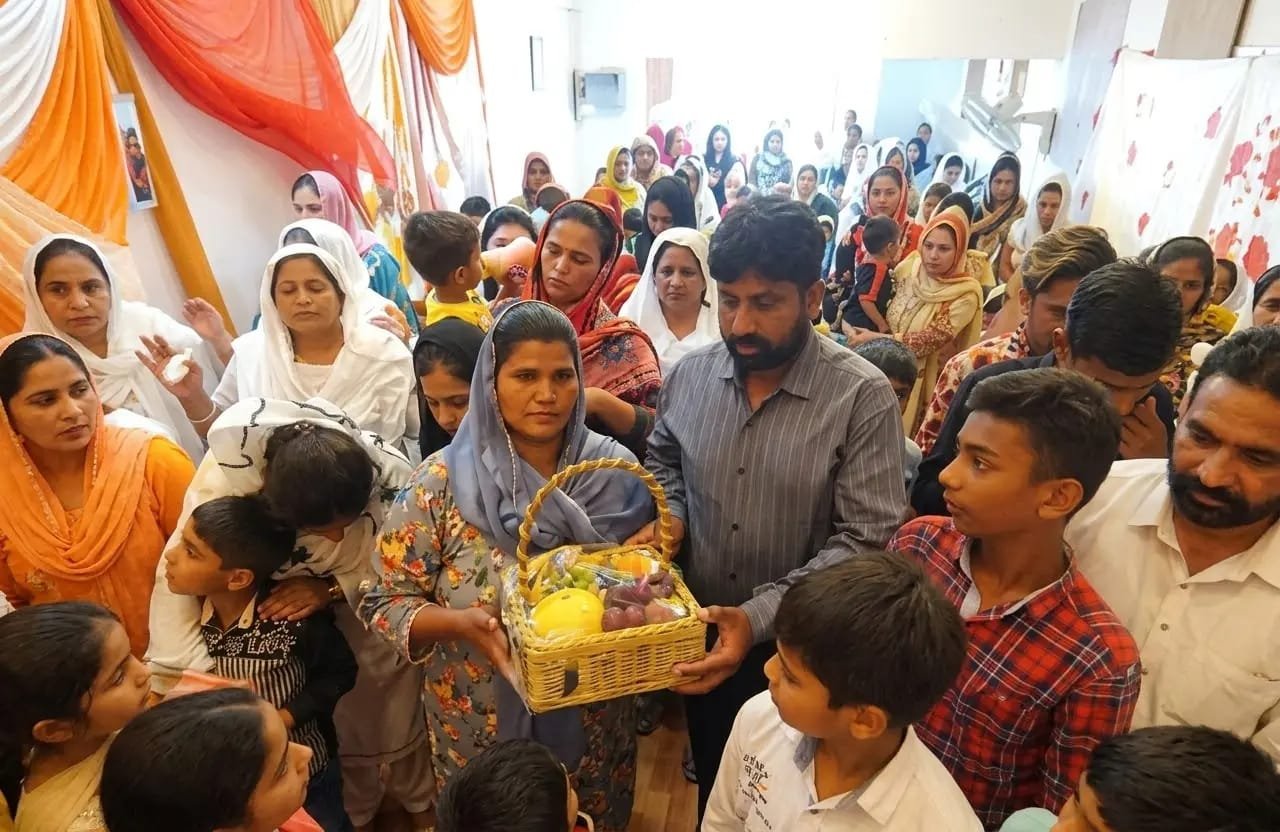 Church member receiving a food basket as an act of compassion at Church of Christ Assembly in Pakistan