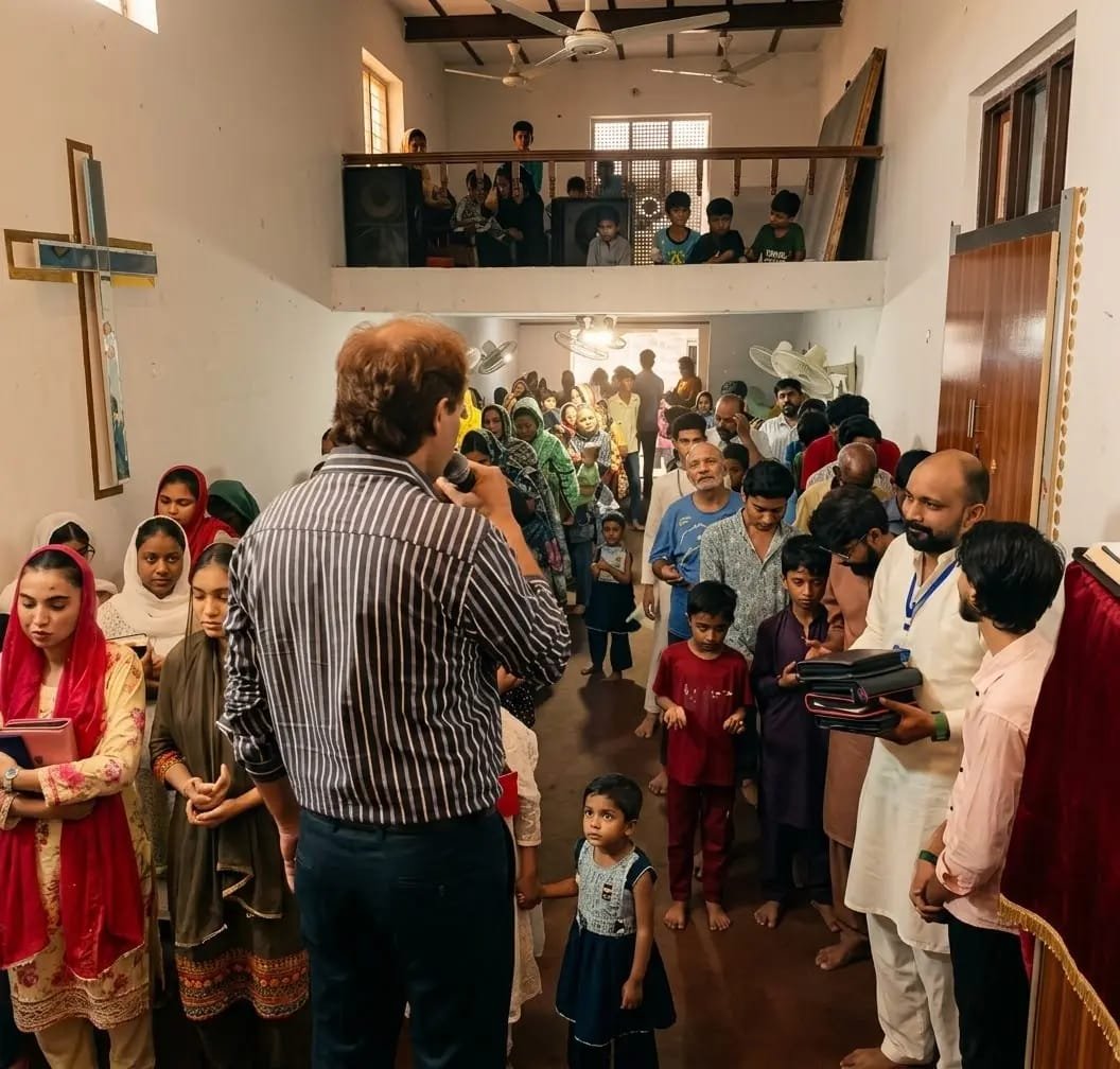 Pastor Yousaf Hussain preaching and distributing Bibles to the congregation at Church of Christ Assembly in Pakistan