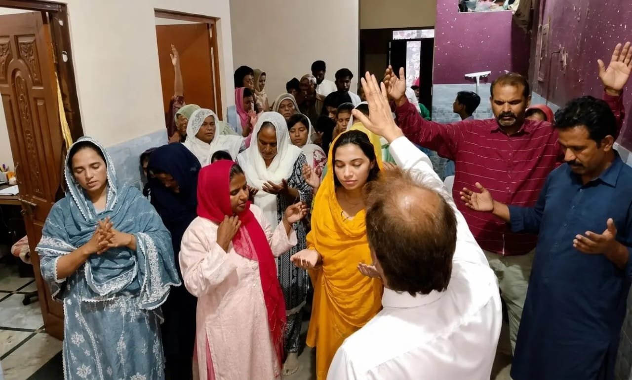 Christian community in intimate prayer gathering at Church of Christ Assembly Lahore