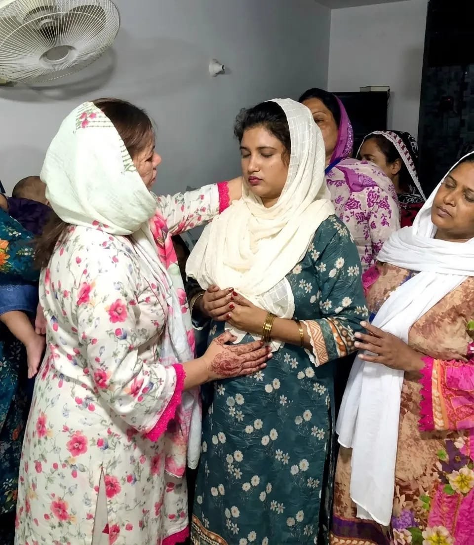 Pastor Yousaf Hussain providing spiritual care and comfort to a church member at Church of Christ Assembly in Pakistan