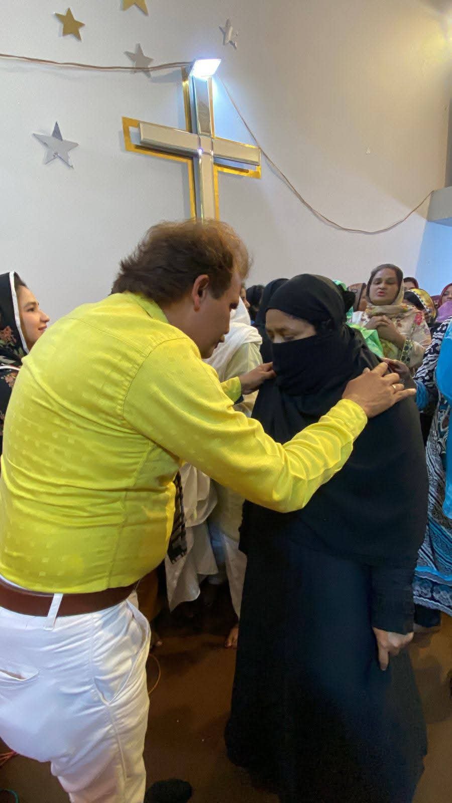 Church member comforted after sharing a testimony at Church of Christ Assembly in Pakistan