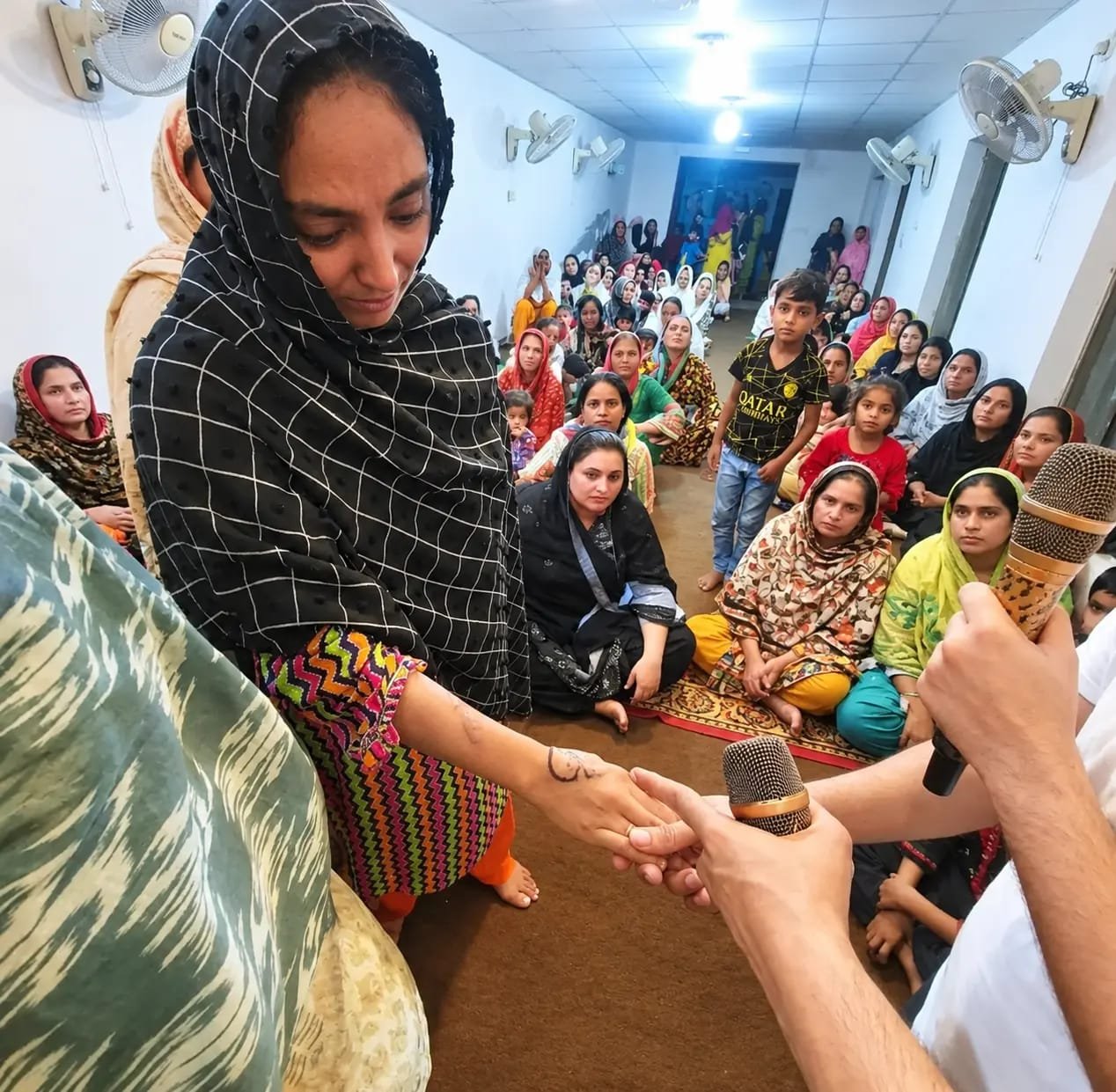 Warm fellowship after sharing a testimony at Church of Christ Assembly in Pakistan