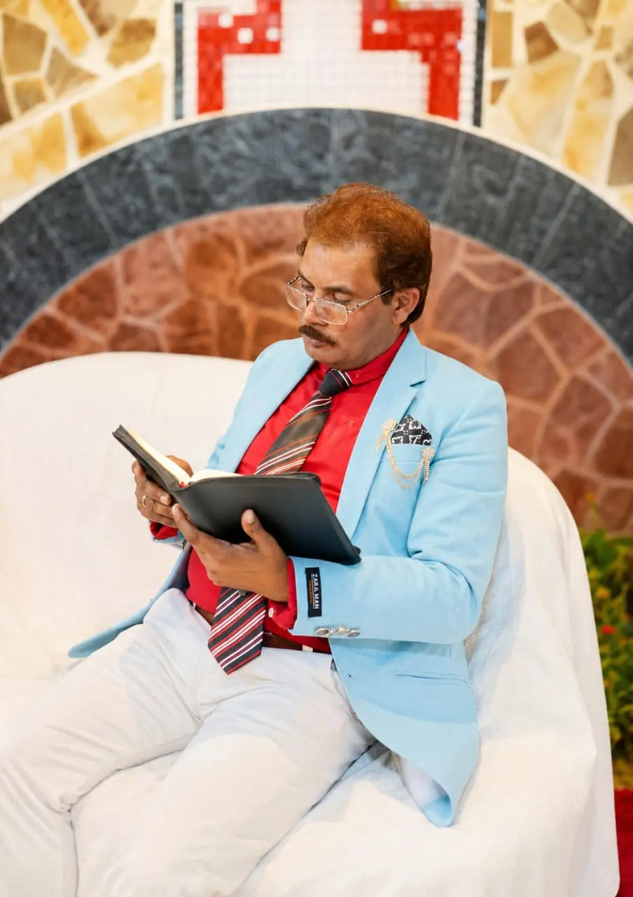 Pastor Yousaf Hussain visionary leader of Church of Christ Assembly Pakistan reading the Holy Bible